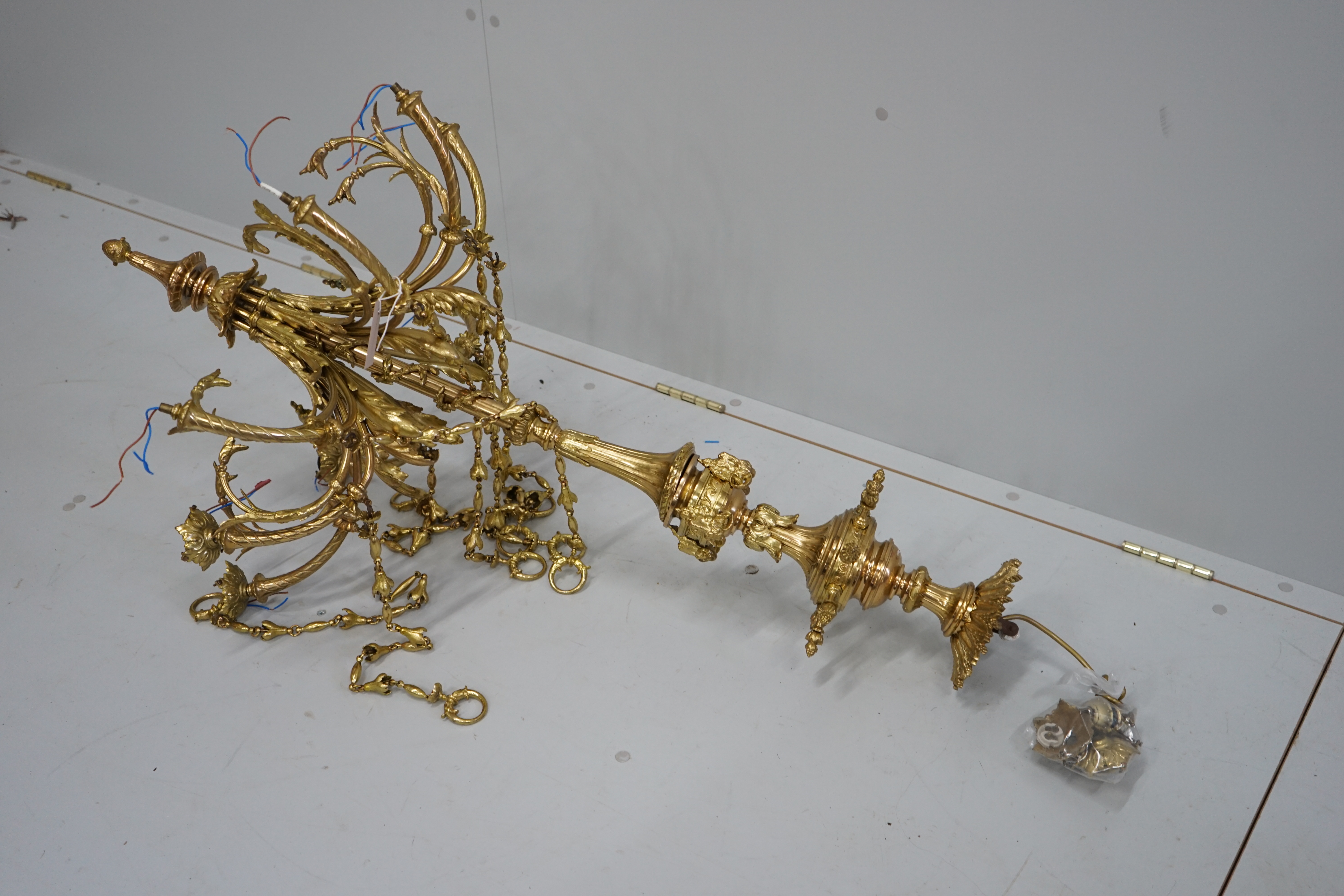 A gilt metal eight branch electrolier, height 106cm